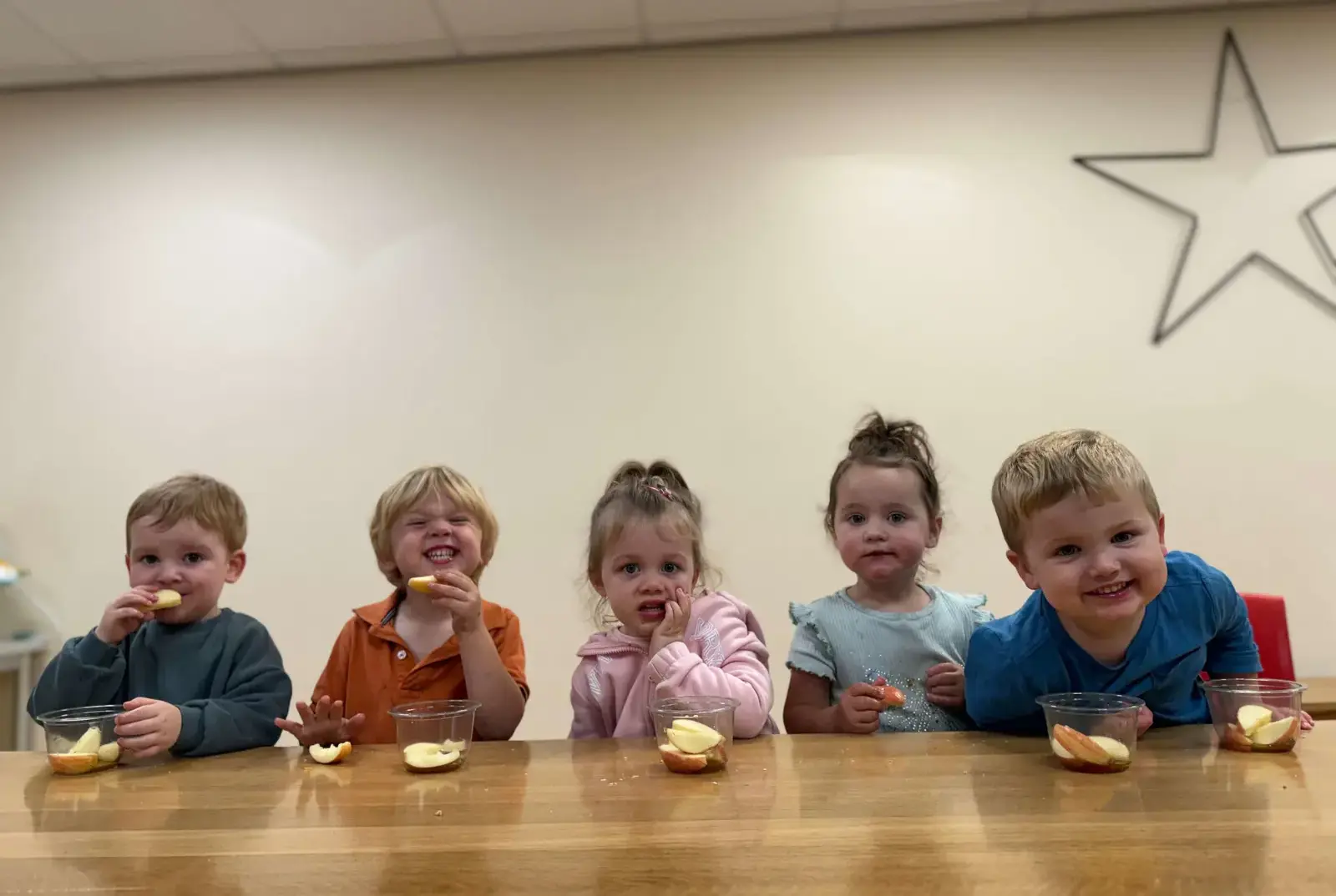 Kindergarten children enjoying healthy eating.