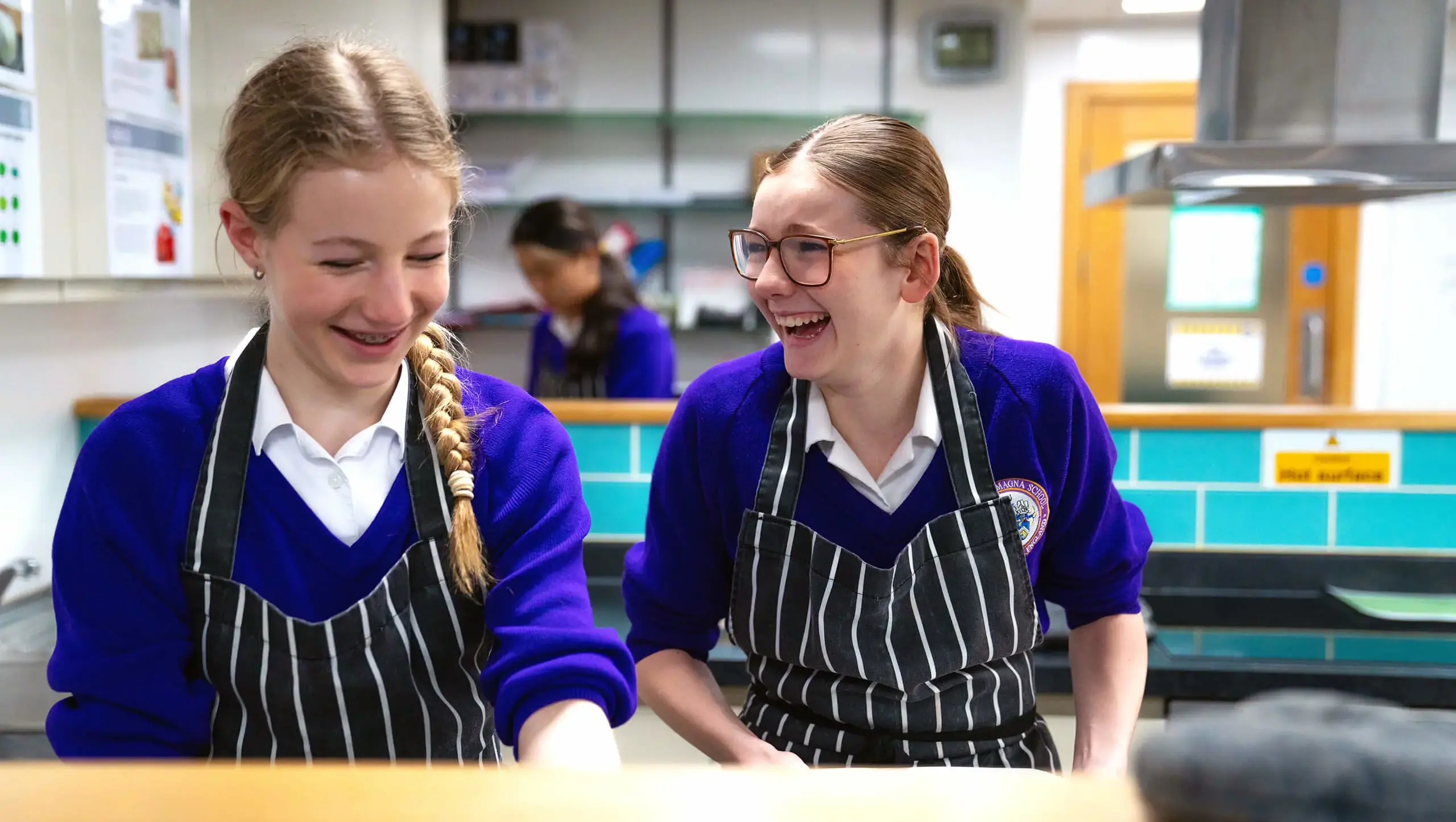 Two middle school students enjoying a food tech lesson.