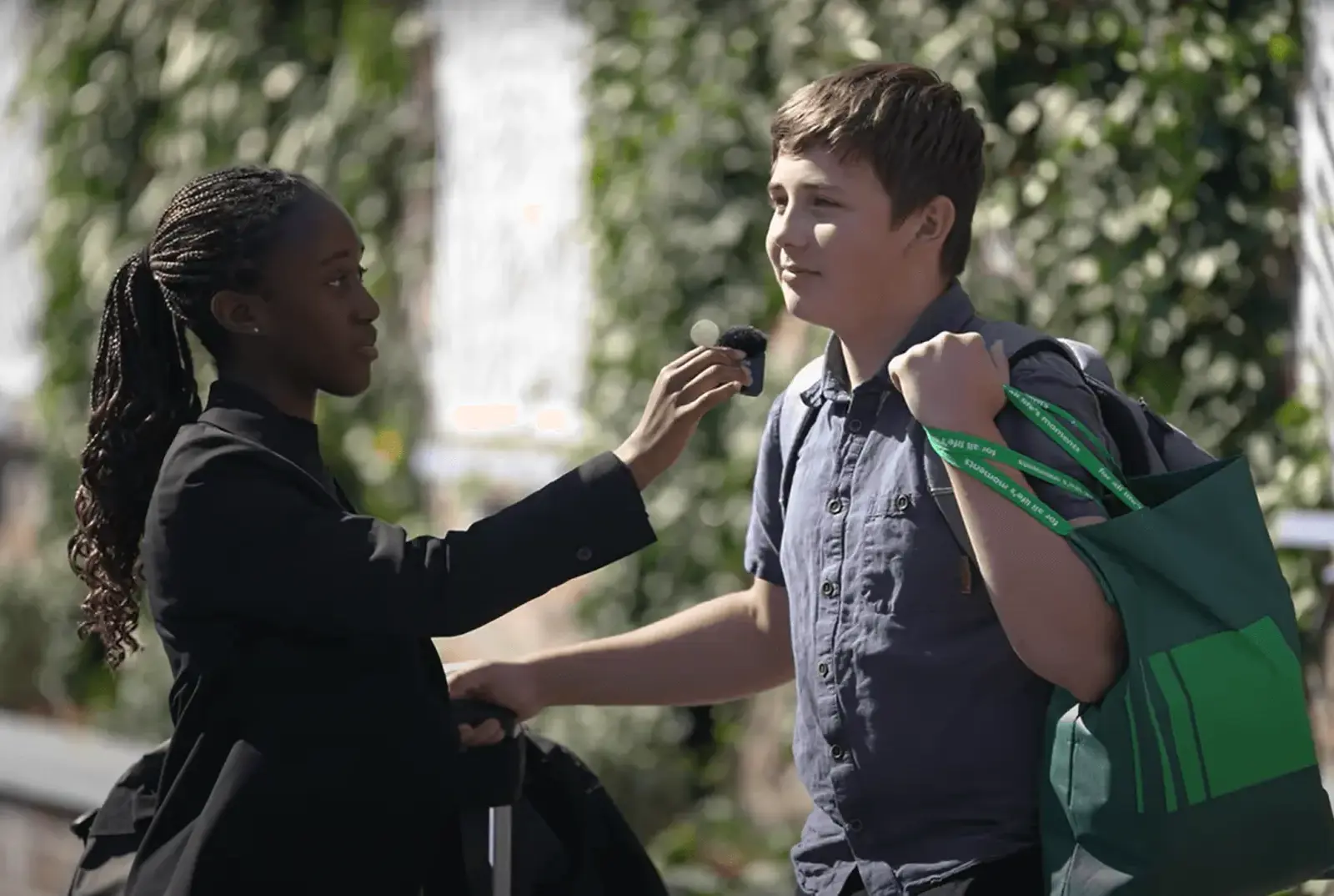 Female sixth form student interviewing a boy.