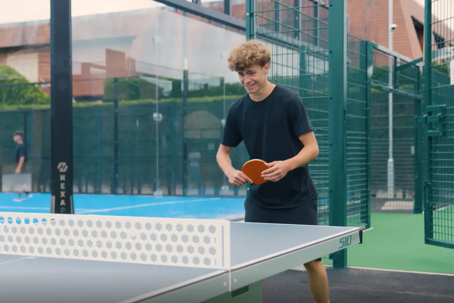 Boy playing table tennis at new outdoor area.