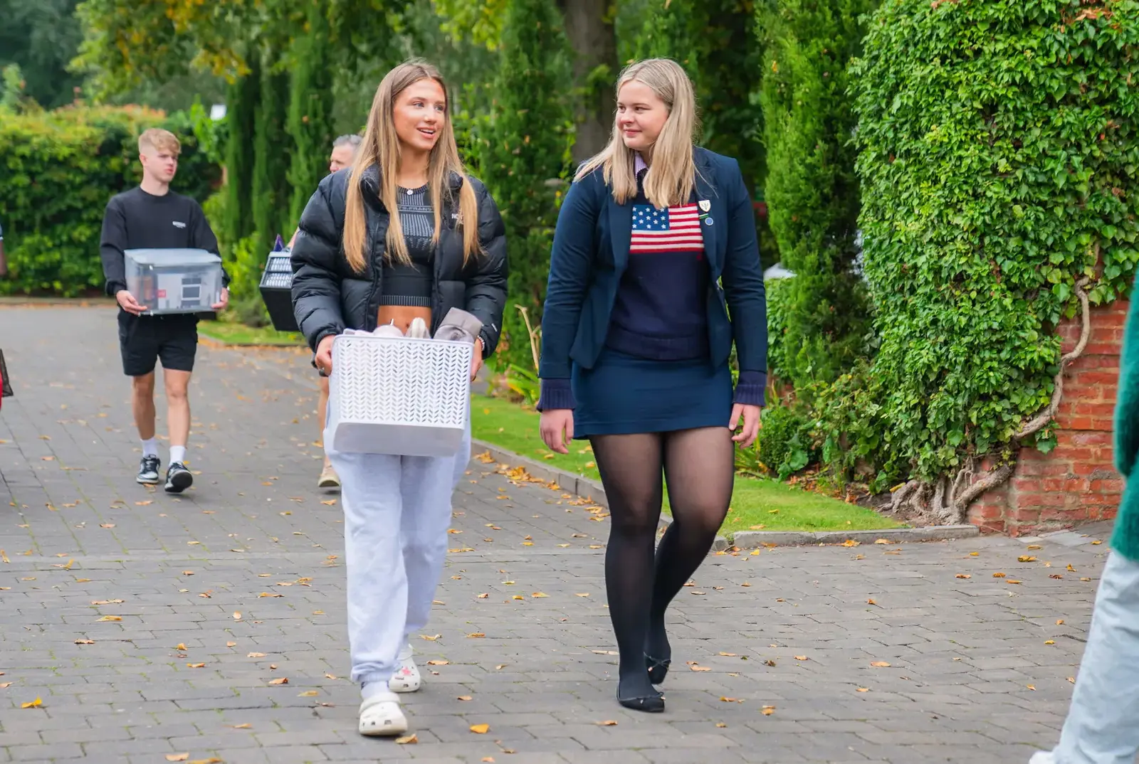Two Sixth Form students bringing luggage to school.