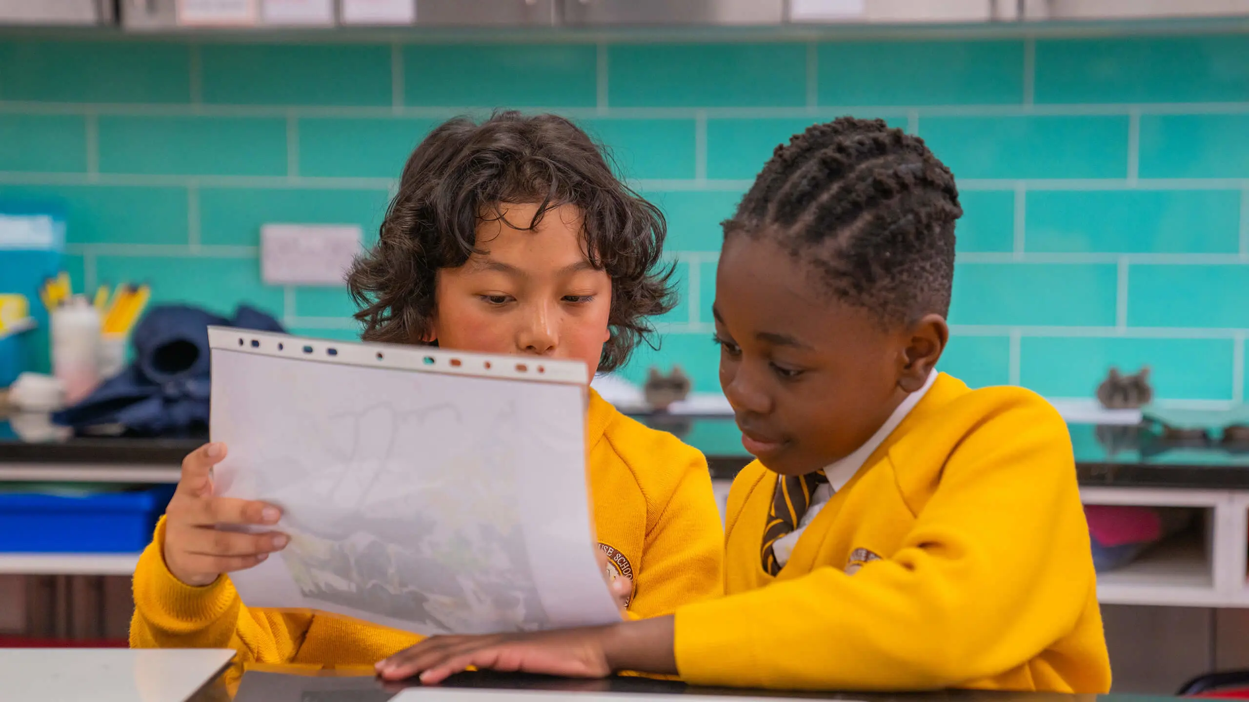 Two private school students studying as part of the academic curriculum.