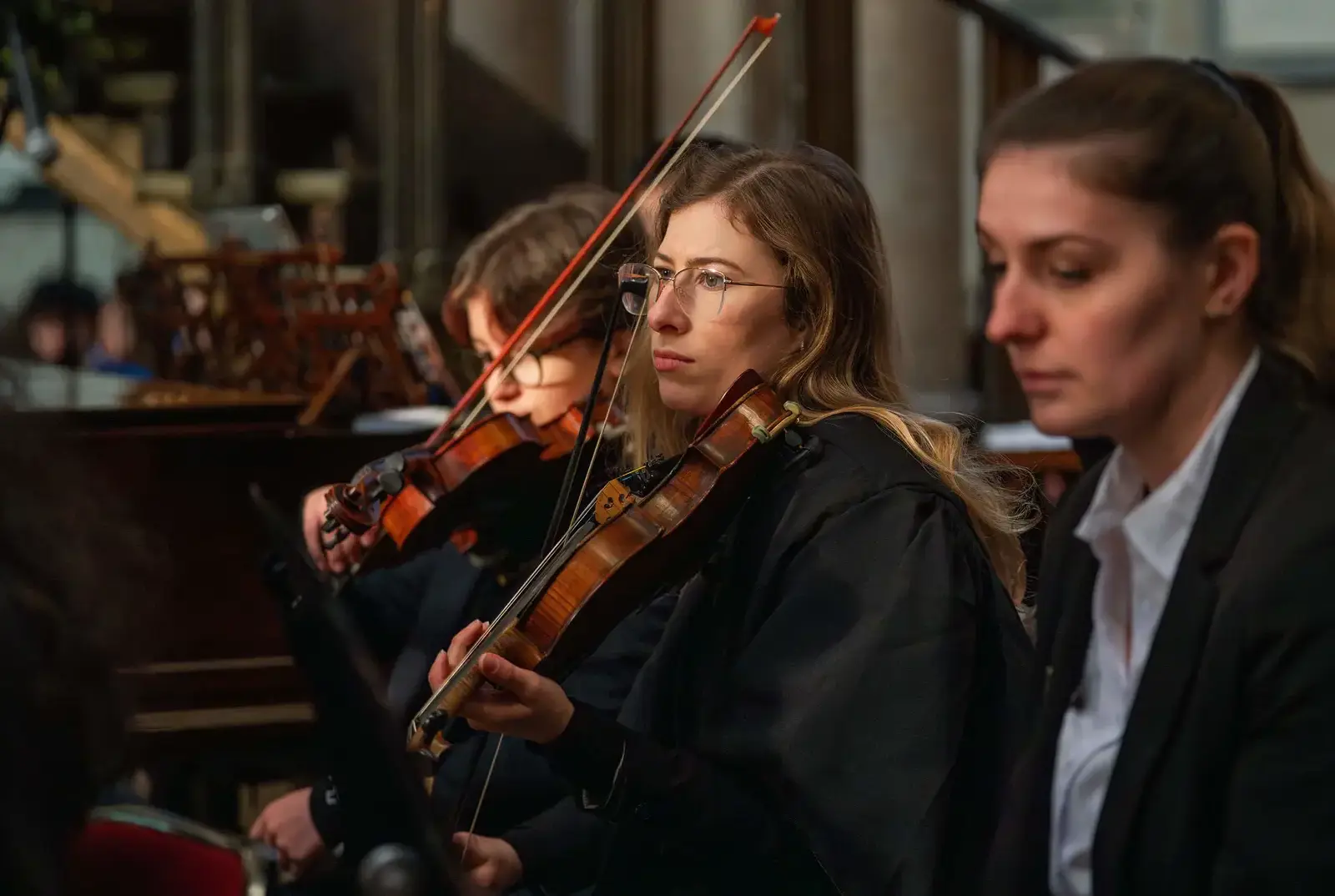 Student playing the violin at the carol service.