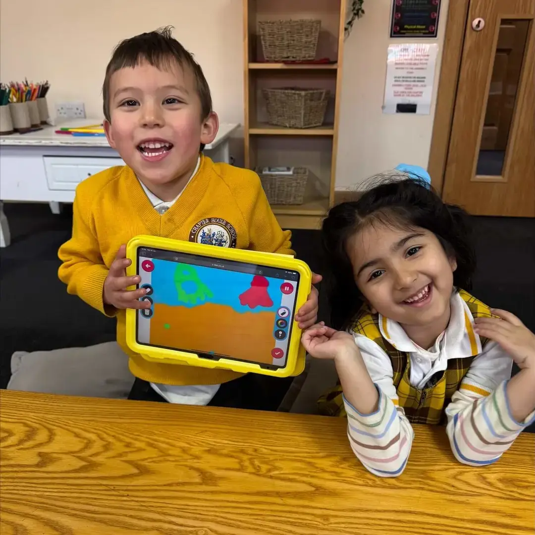 EYFS children drawing on tablets.