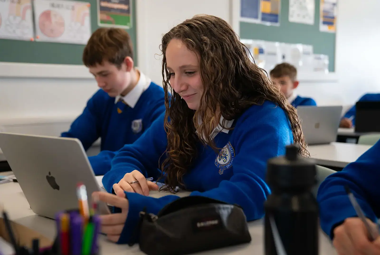 A student on a laptop in a computing theory lesson.