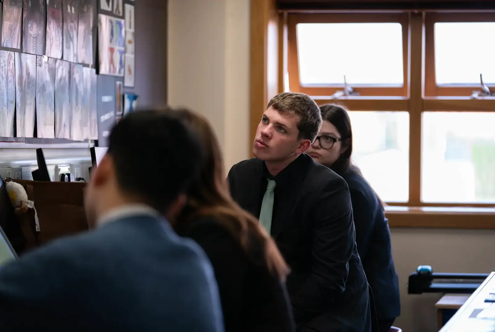Student looking at artwork in a Creative Arts lesson.