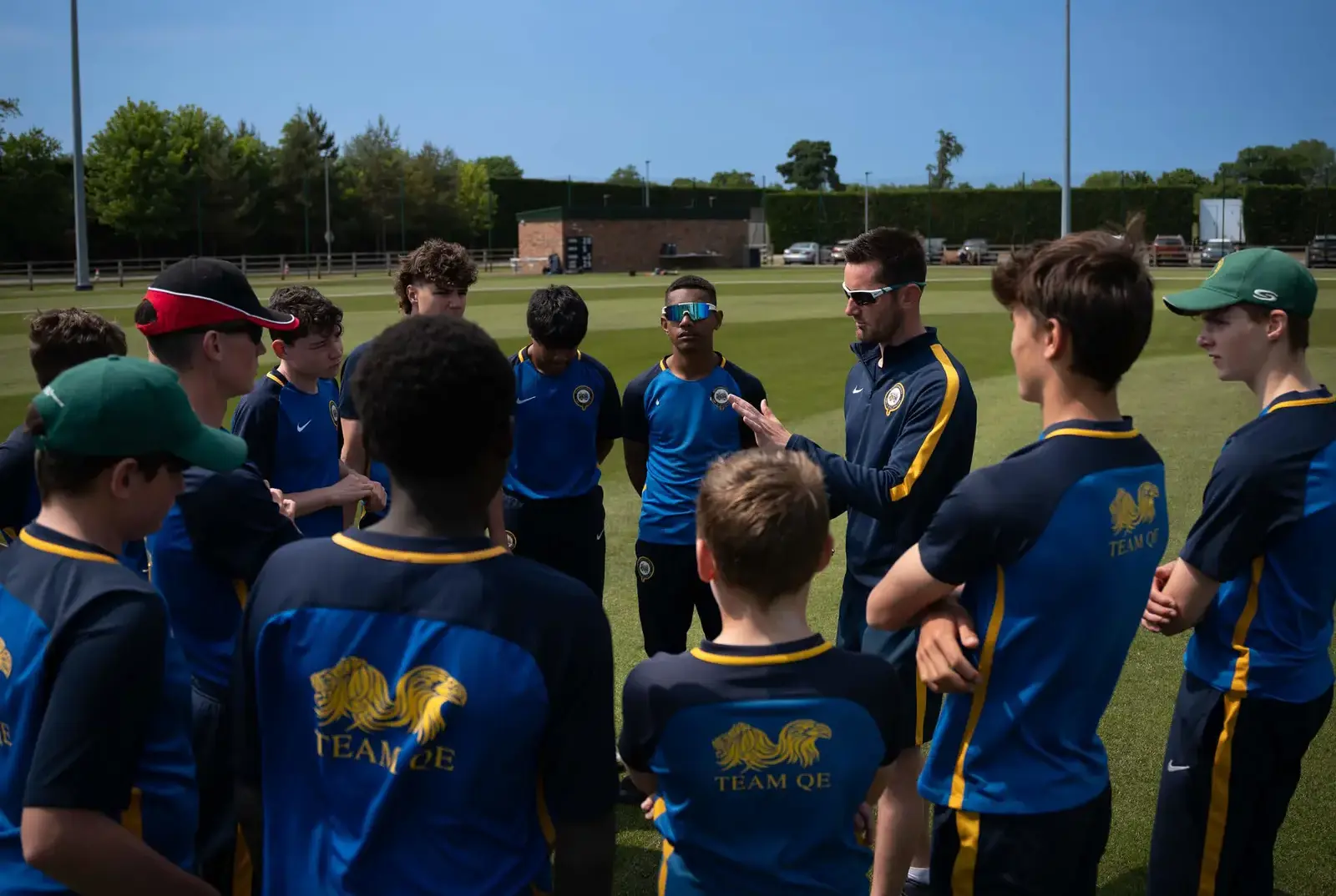 Students with their cricket teacher at QE