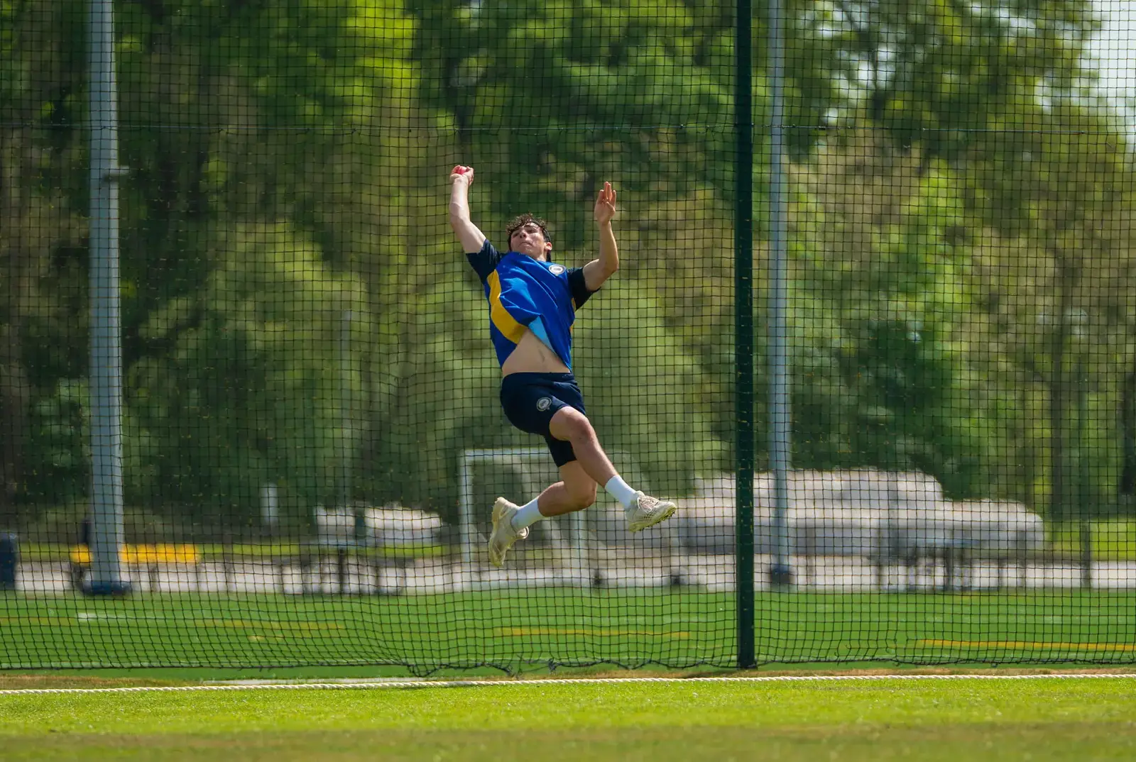 Student playing cricket at QE.