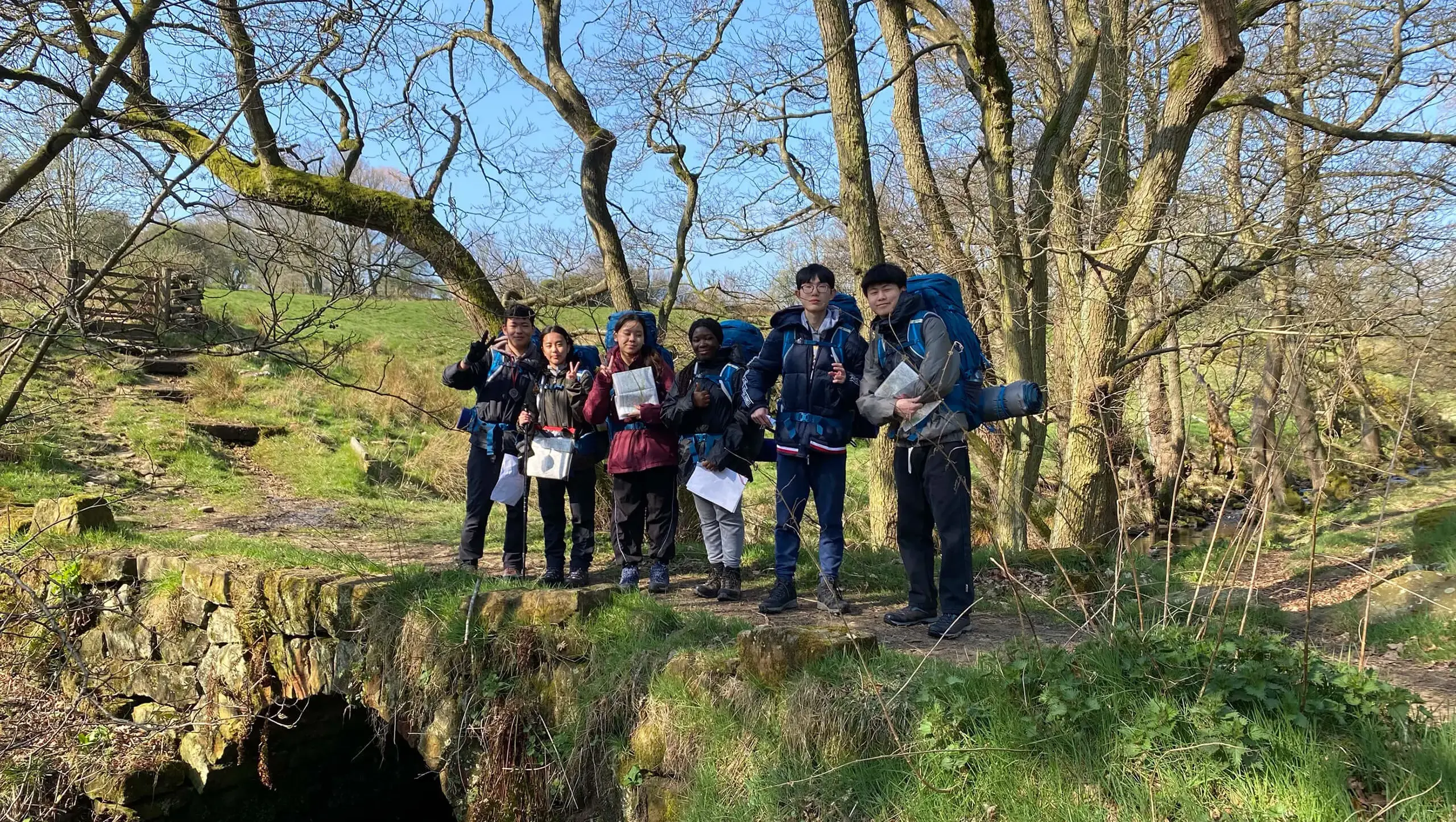 Duke of Edinburgh students walking across the bridge.