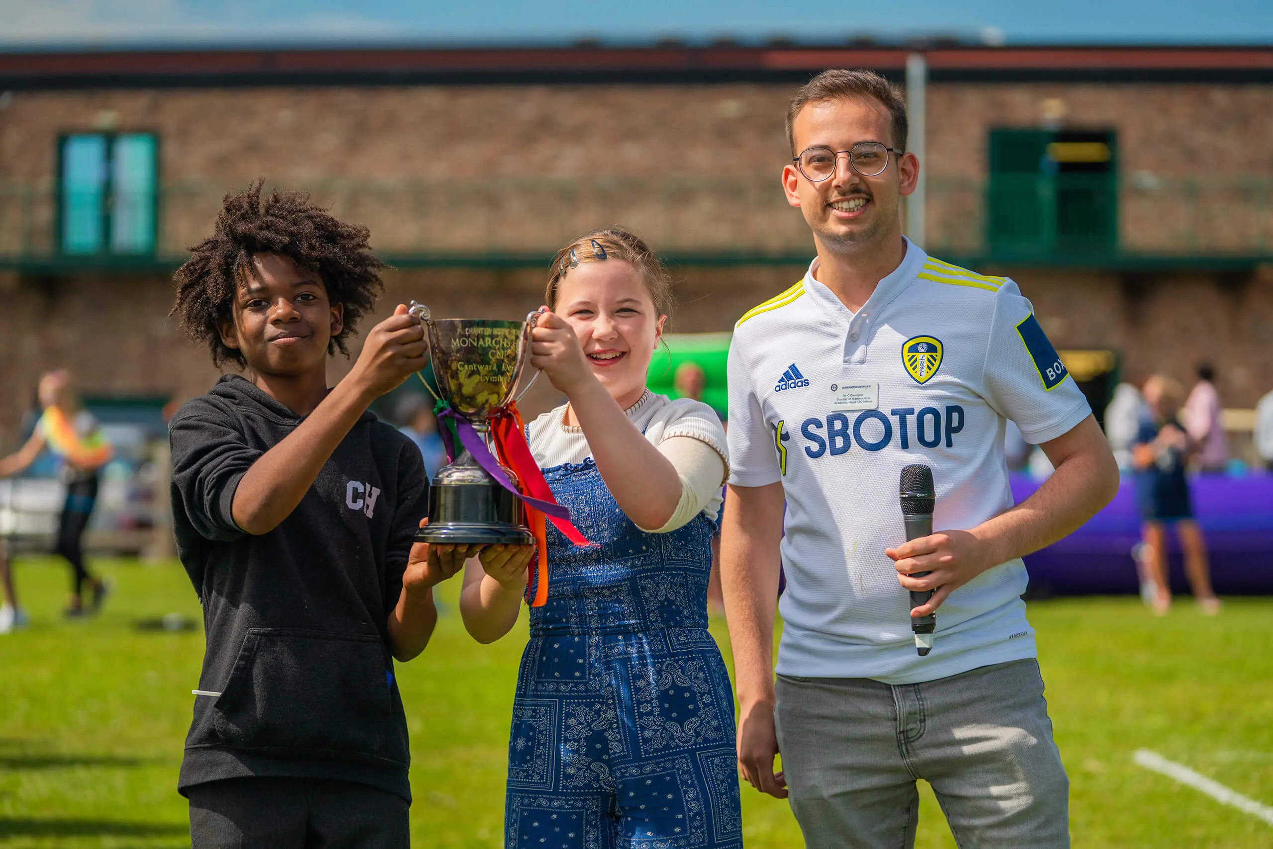 Students smiling with the enrichment cup.