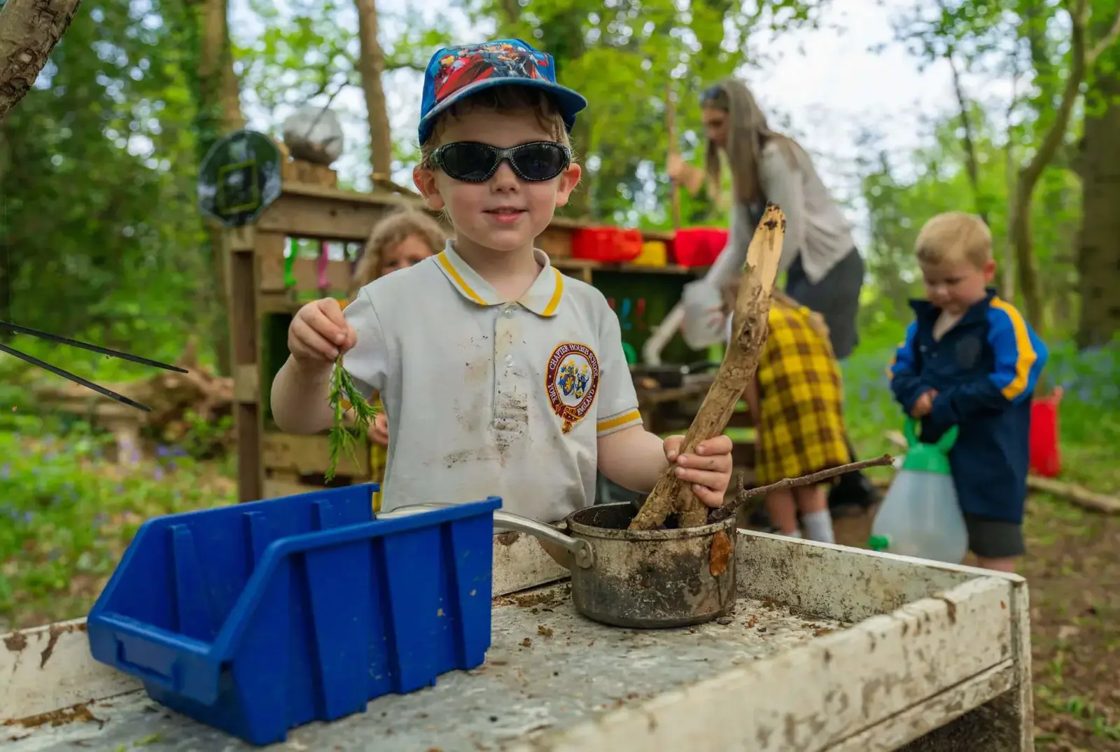 Boy stirring up a mud cake.