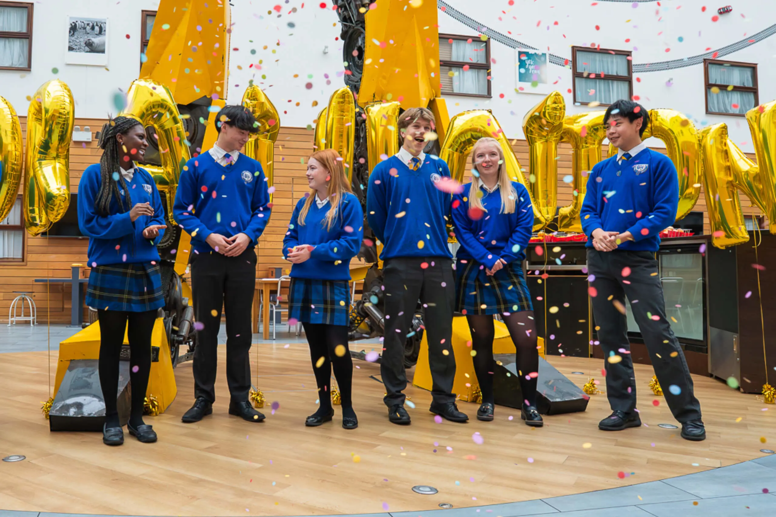 Students celebrating GSCE results at Queen Ethelburga's, a private day and boarding school in Yorkshire.