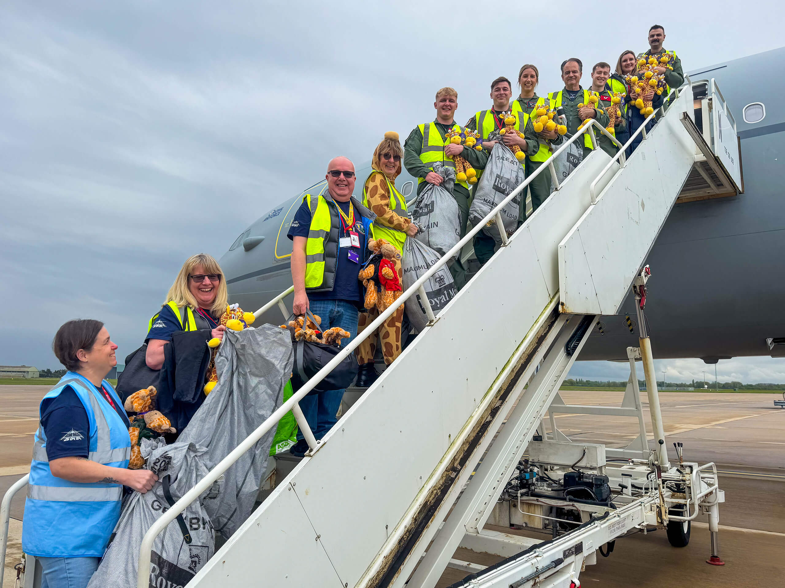 Team from Giraffes on Tour boarding the teddies on the plane.