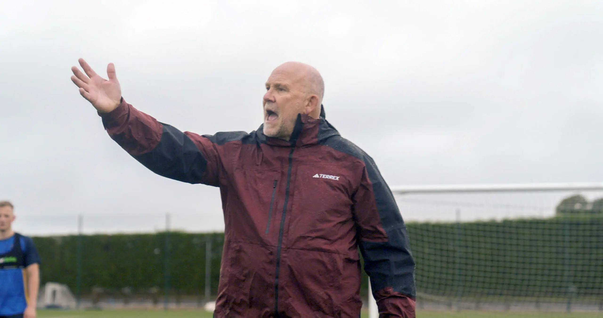 Mike Phelan teaching girls on the pitch.