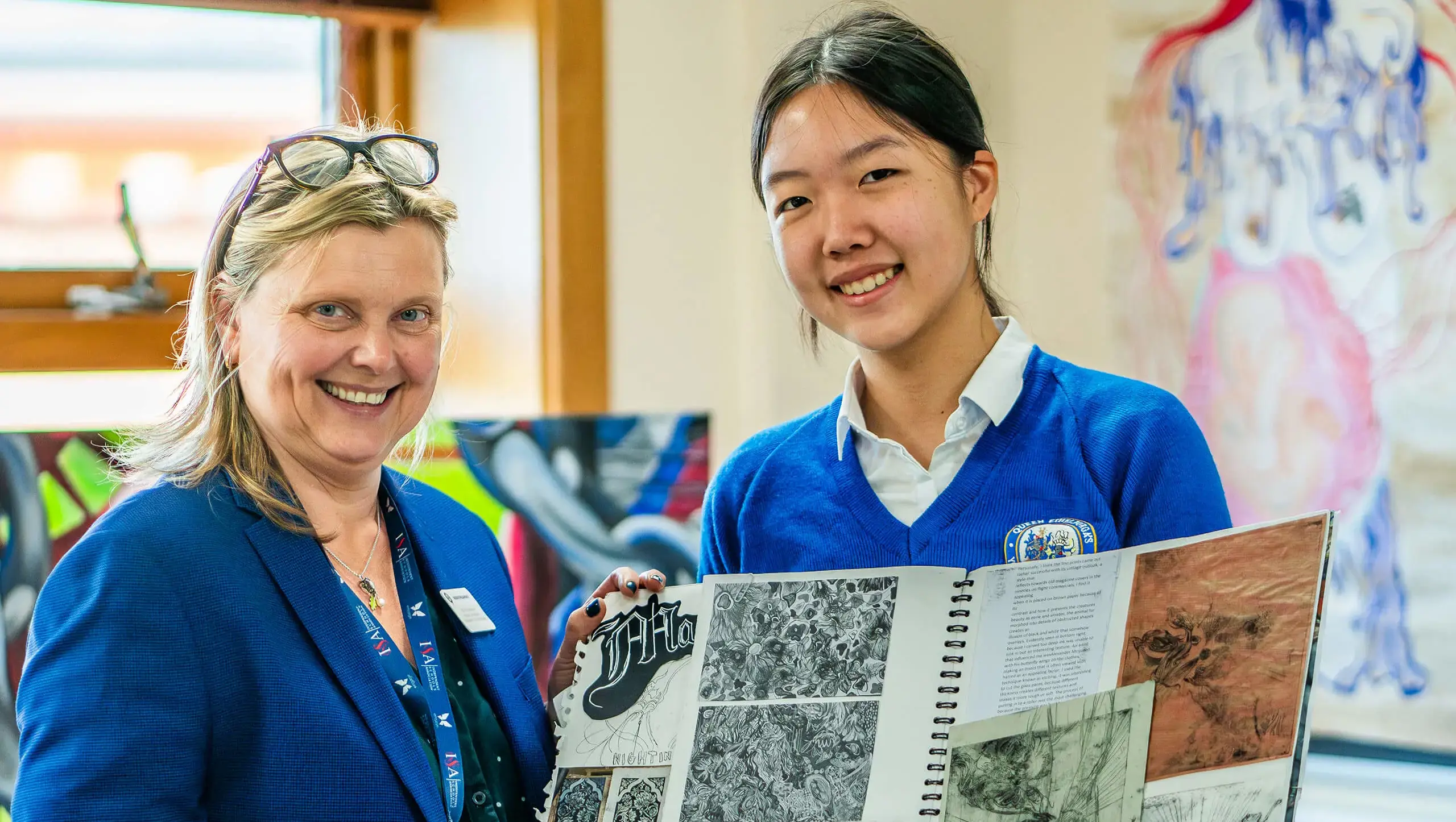 Queen Ethelburga's pupil with her artwork and a teacher