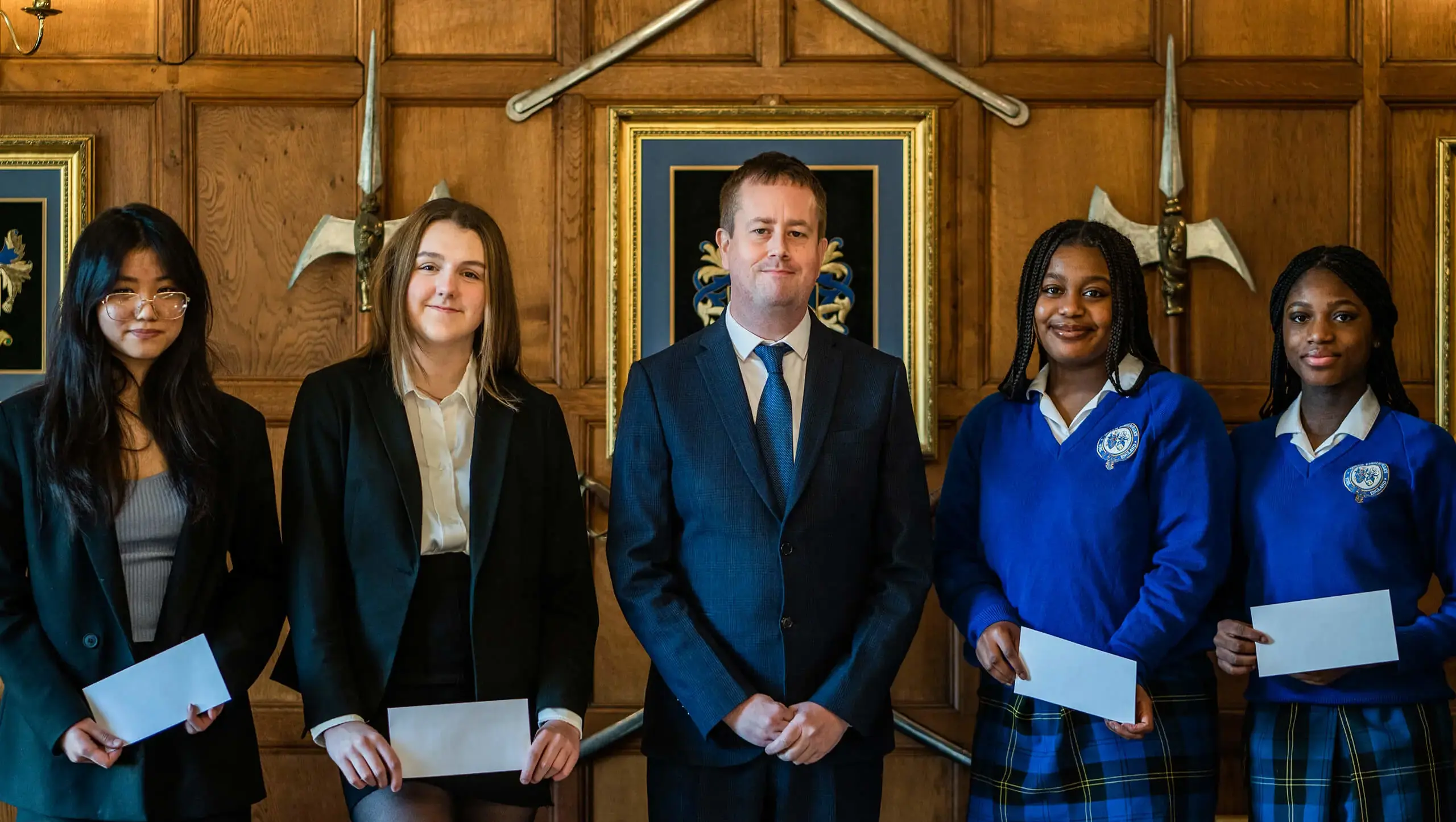 Students at York boarding school smiling next to Head Teacher, Dan Machin.