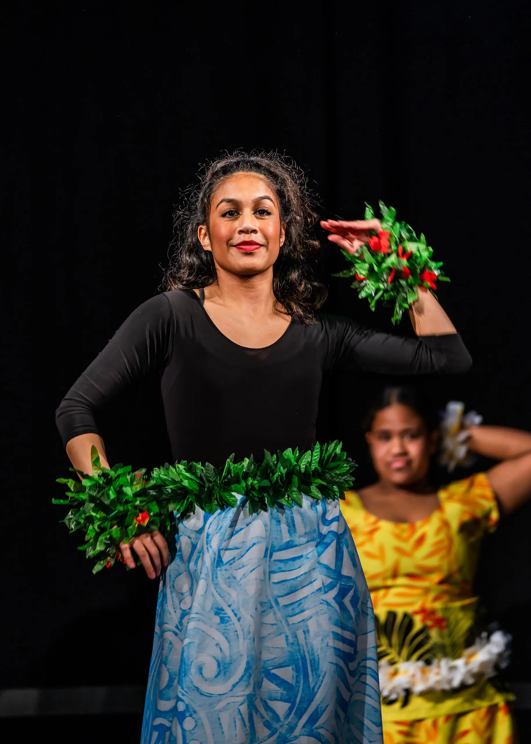 QE Faculty student performing on stage