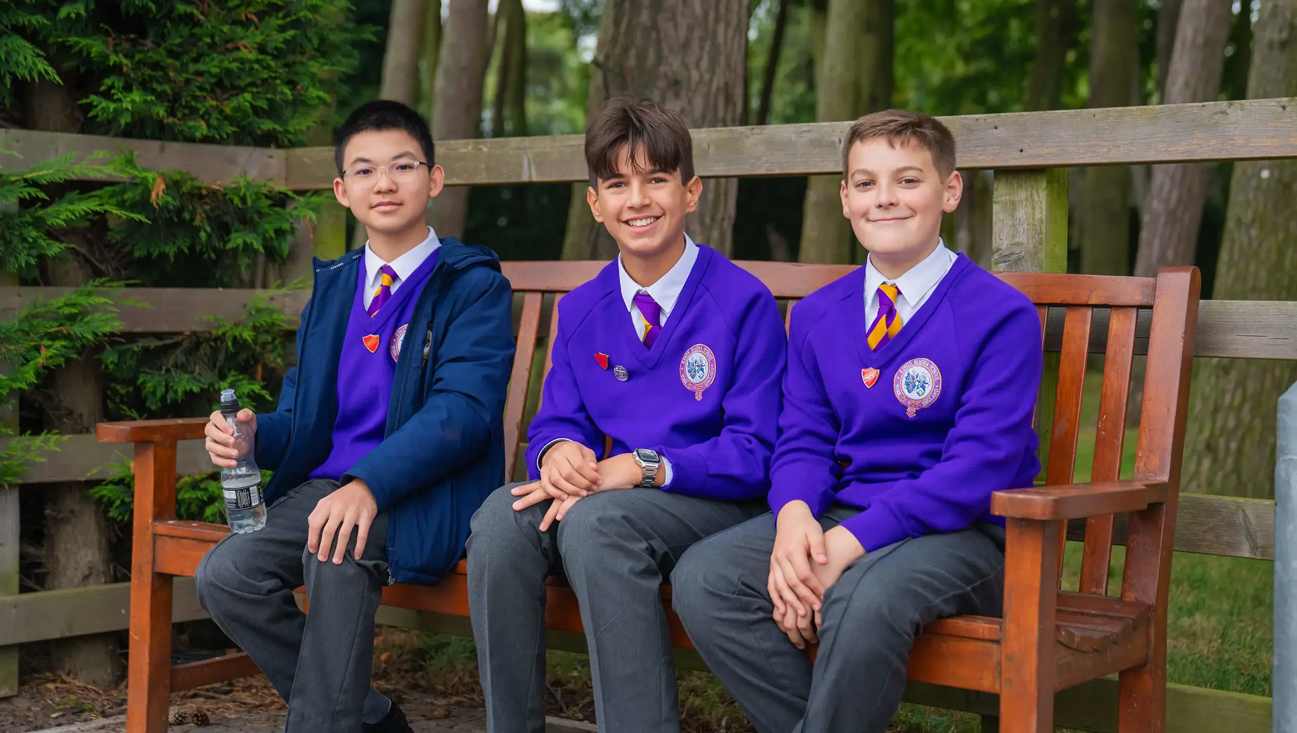 King's Magna students smiling on a bench.