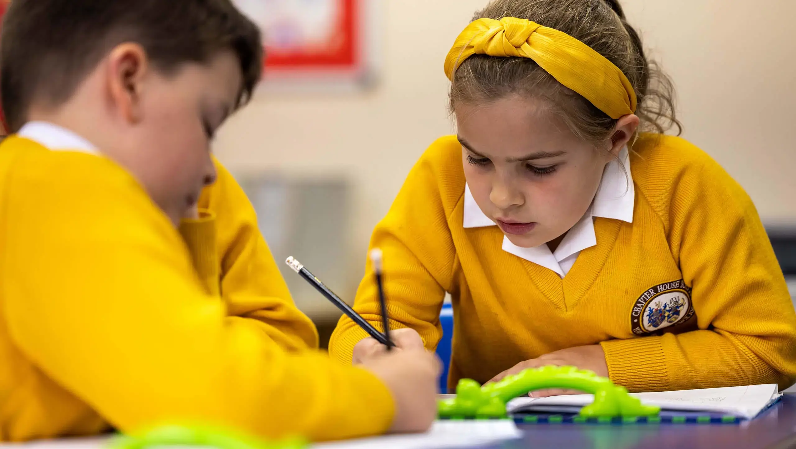 Young pupils studying in class at Chapter House, a primary school near York.