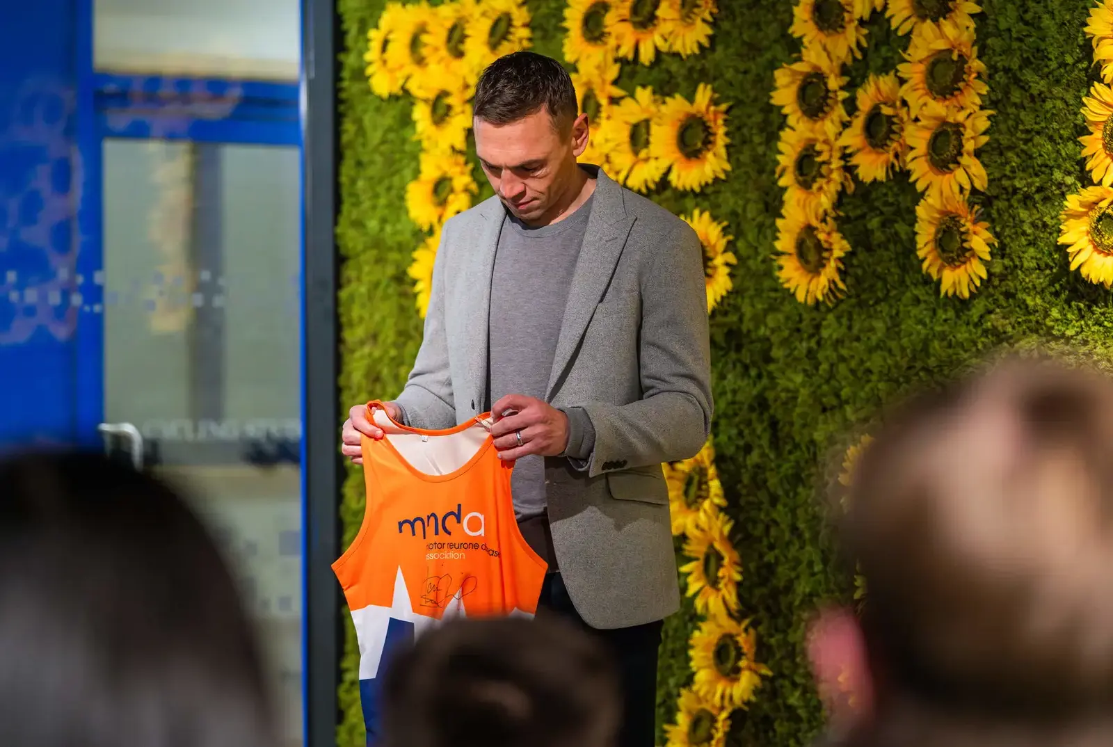 Kevin Sinfield holding a signed top,