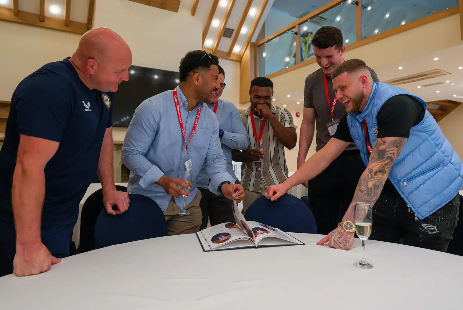 Rugby Alumni looking back on their year book.