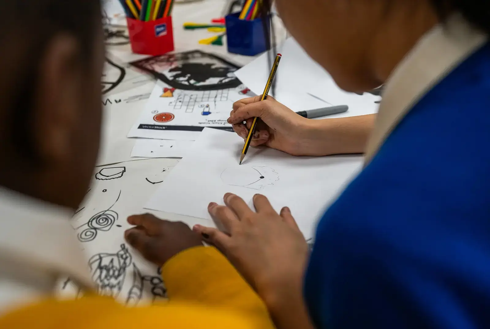 Two students from Queen Ethelburga's helping at an Outreach event.