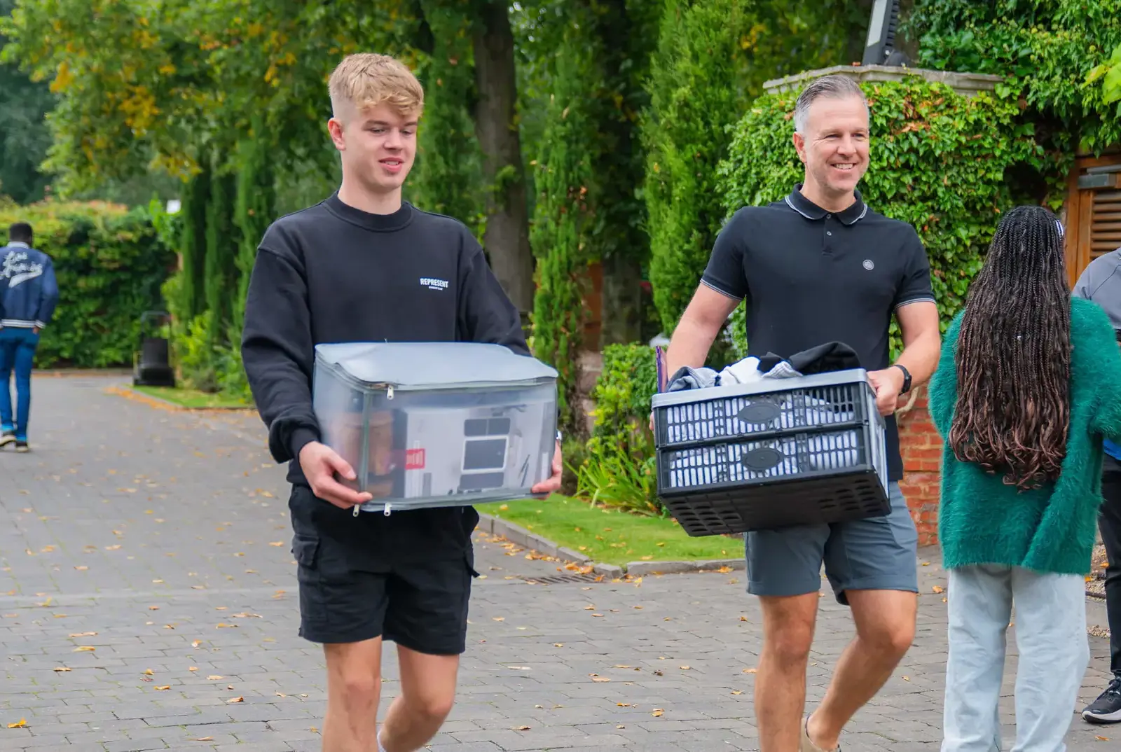 Dad and son carrying luggage for boarding.