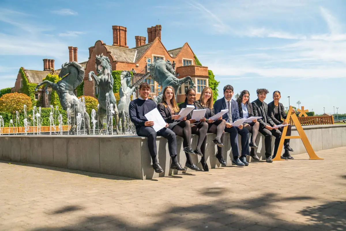 Students sat at the horse fountain.