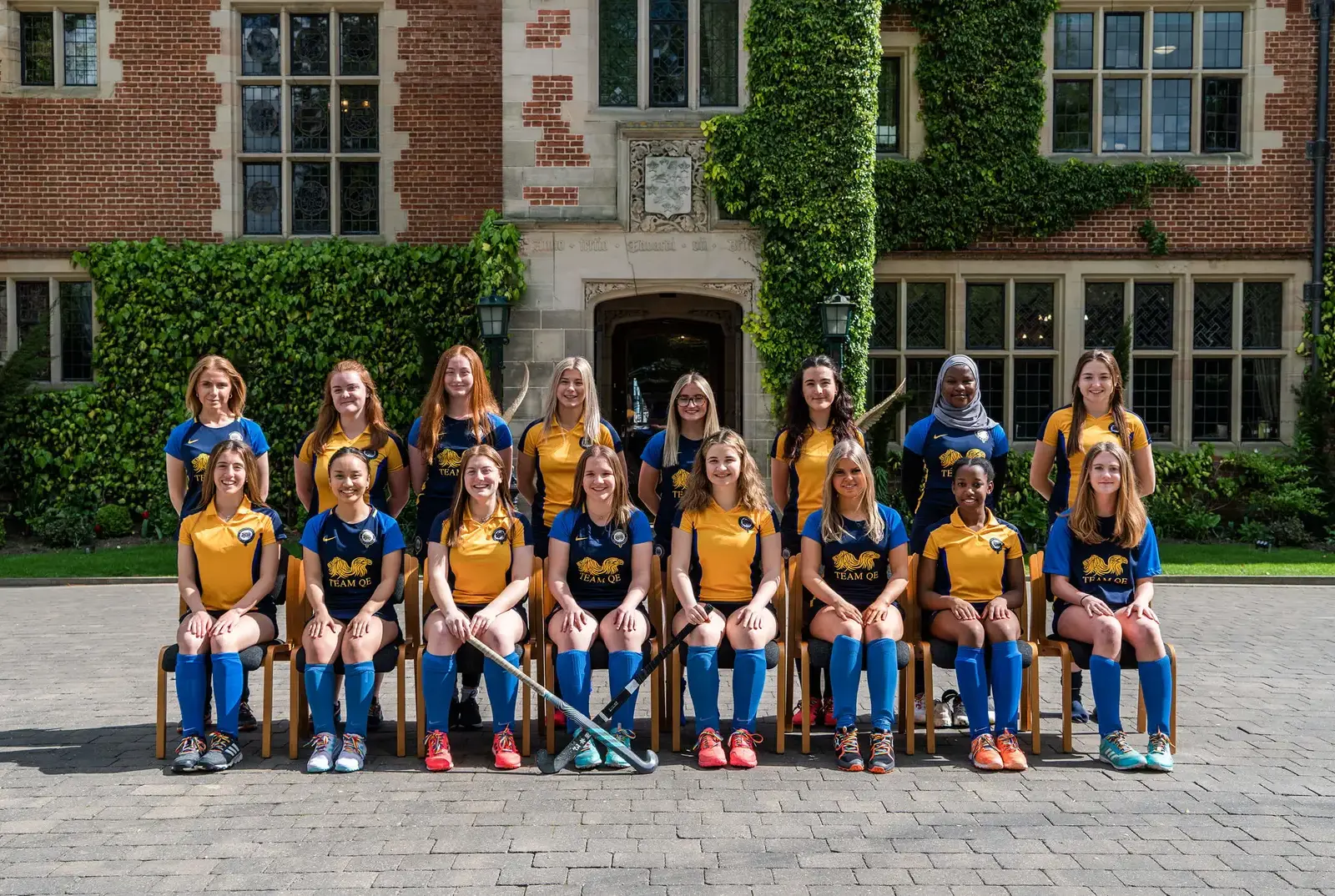 Girl playing hockey at the OE vs QE event. 