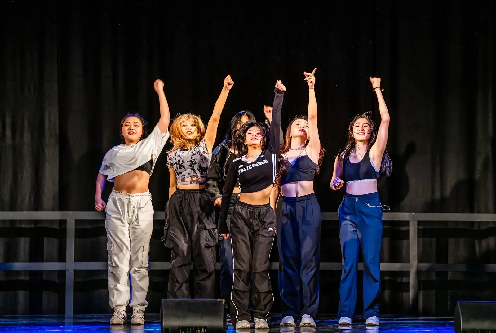 Queen Ethelburga's students dancing on stage