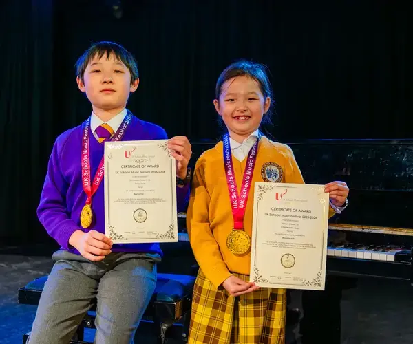 Two pupils from Queen Ethelburga's, a private day and boarding school in Yorkshire, celebrating their awards